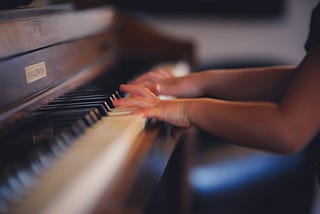 A picture of a person playing piano.