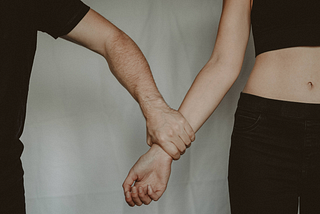 A man holding a woman’s arm