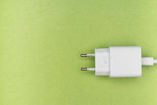 a white power plug against a green background