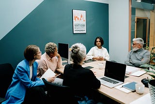 Founders sit around a desk