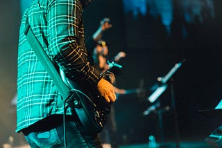 An anonymous guitarist performing onstage