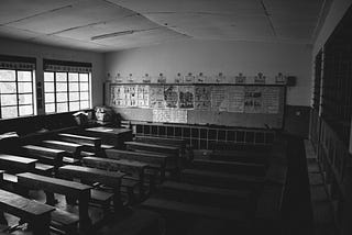 a black and white photo of an empty classroom