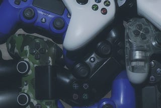 Game controllers in a pile. Treating real life like a video game.