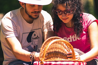 Husband and wife opening a picnic basket