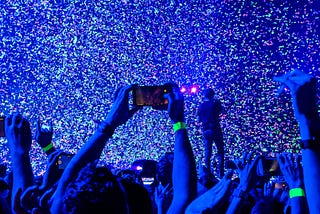 The image is of a concert, but represents the poet in a place where he is surrounded by the world, yet lost in his mind