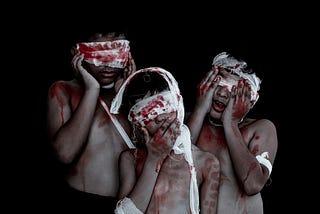 three children with bloodied bandages on their heads and arms