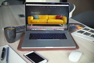 Landing page with a yellow sofa on Macbook