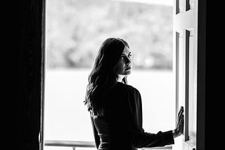 A woman standing in an open doorway.