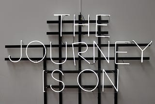 Signage with words “The Journey is On”