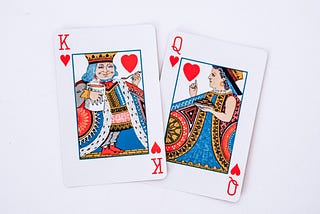 Two playing cards: one king and one queen.