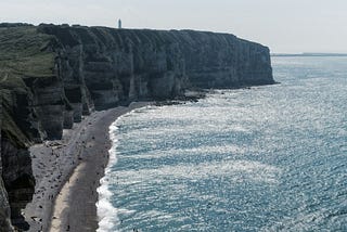 Massive cliffs tower over the Beaches of Normandy and the English Channel.
