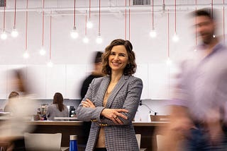 Woman smiling in office with blurry background