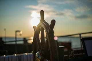 A boat’s wooden steering wheel