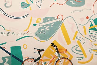 Multi-colored background behind bike.