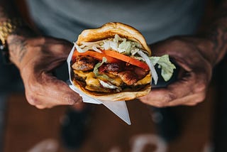 Man holding a chicken burger