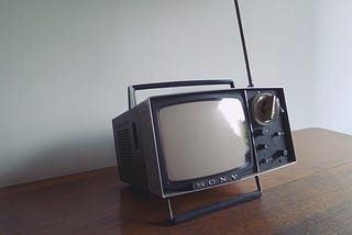 Vintage portable television sitting on table | When Therapy Wasn’t an Option, I Found Morning TV | Live television taught me what children’s shows could not | Nikki Abelson