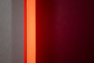 An abstract Rothko-esque image of gray, orange, and crimson