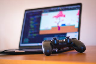 Image of a laptop and a game controller.