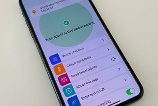 A smart phone with the NHS covid test and trace application open