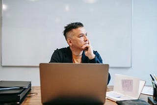 A man sits and thinks
