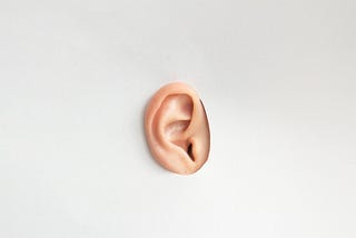 An ear on a white background representing audio and the ability to hear