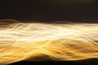A “million” golden lines of light intertwined like wires against a black background.