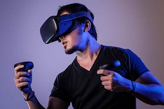A Video gamer wearing AR (Augmeneted Reality) headset and having AR controllers in both the hands