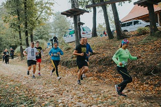 People running in the woods.