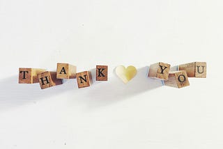 the word thank you in wooden blocks on a white background