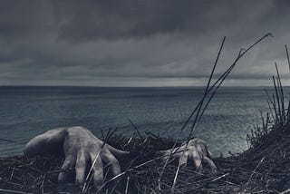 creepy white hands claw their way up a cliff overlooking a large body of water. clouds hang low in the background