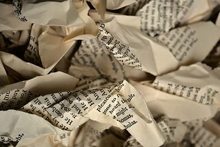 A pile of torn and crumpled book pages.