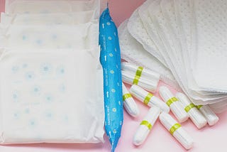 A close up of pads and tampons laid out on a table.