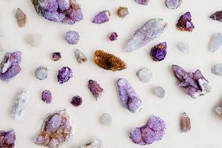 Various-sized amethyst crystals laid out on a surface.