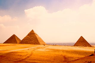 Giza Necropolis seen from far away symbolizing the sweet results at the end of a long doubtful road.