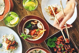 A whole bunch of Thai food sitting nicely on a table.