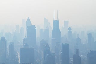 Shanghai cityscape. Pollution casts the buildings in a dismal, monochromatic haze.