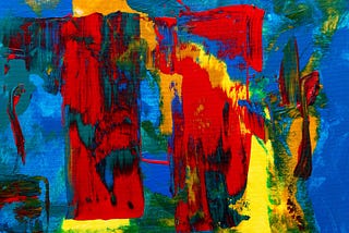 An abstract painting of red, blue, green, and yellow.