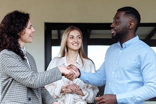 A woman introducing two people as potential partners, a practice found in the history of matchmaking.