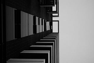 An abstract-ish photo. It looks like it’s a shot of a building taken from the ground, looking up. The building fills two thirds of the frame, and then sky fills the next third.
