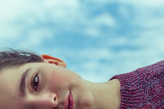 A young child looking sideways.
