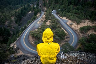 Person overlooking a crossroads on a mountain top