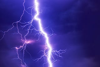 Lightning image in stormy cloud backdrop.