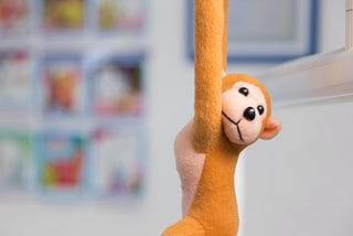 Stuffed toy monkey hanging in the air