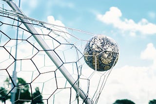 soccer ball in back of the net