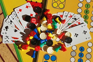 cards and brightly colored game pieces on a yellow game board