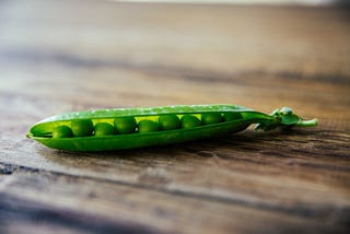 A green set of beans on a table