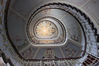 A view from below a grand ornate staircase