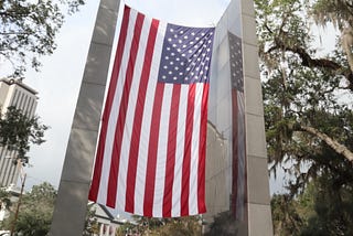 A large American flag hangs on a sculpture wall in Florida’s capitol city, Tallahassee.