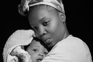 black and white picture of a lady holding a baby