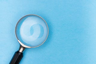 A magnifying glass on a light blue background